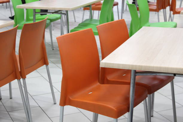 istock Tables and chairs stand in an empty cafe without people. 1403628913