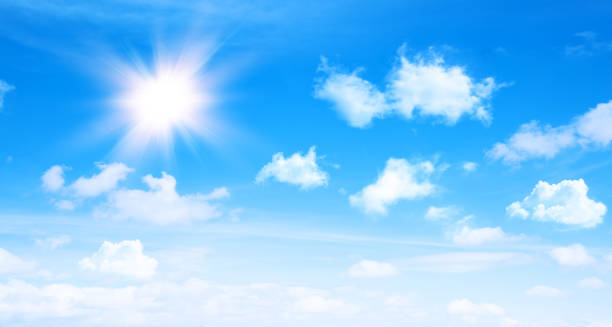 istock Sunny day background, blue sky with white cumulus clouds and glaring sun 1403628929