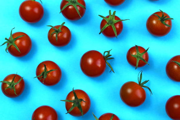 istock Texture from red ripe tomatoes on a blue background. 1403630137