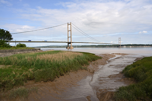 This view of the south side of the Humber Bridge at Barton upon Humber. England, the bridge is a 2.22 km single-span road suspension toll bridge that crosses the river Humber north to Hessle. The Bridge opened to traffic on 24 June 1981