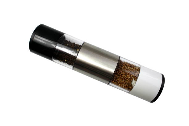 A spice grinder with polka dots lies on a white background.
