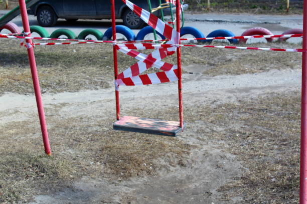 istock Children's swings are wrapped with prohibition tape. 1403630657