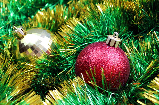 Christmas background from green tinsel with Christmas balls.