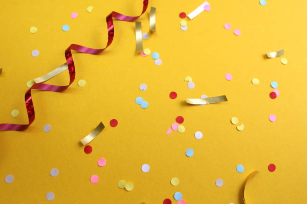 istock Festive background with confetti on a yellow background. 1403633025
