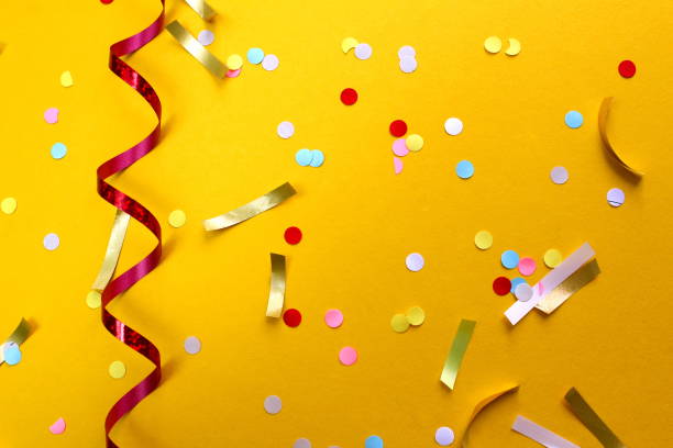 istock Festive background with confetti on a yellow background. 1403633043
