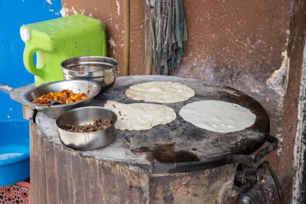 istock Mexican tortillas prepared on a traditional griddle (translation: comal) 1403634750