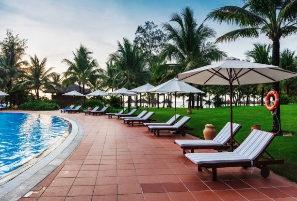 istock beautiful swimming pool in a tropical resort 1403636263
