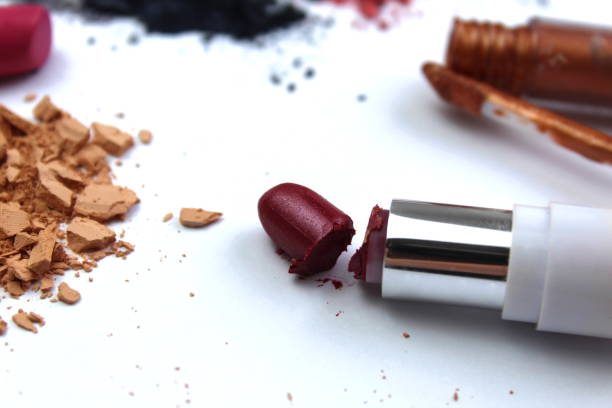 istock Different cosmetics, open, broken, scattered and spilled lies on a white background. 1403636330