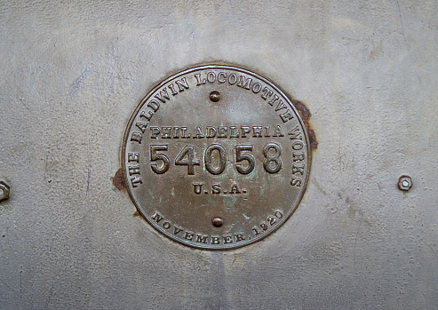 Metal plate detail of a Baldwin \n54058 locomotive. June 12, 2022. Jaguariuna, State of São Paulo, Brazil