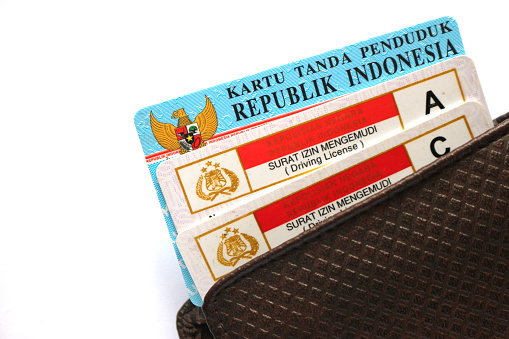 Indonesian citizenship identity card and driving license in a wallet.