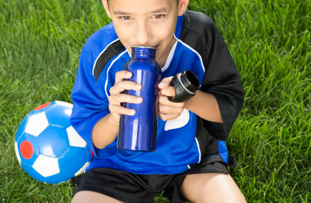 istock Little boy soccer player drinking water bottle 1403638451