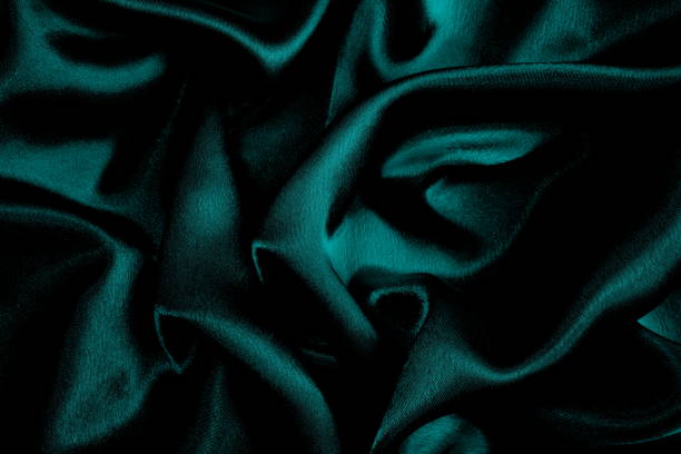 istock Background of turquoise draped satin fabric. 1403638458