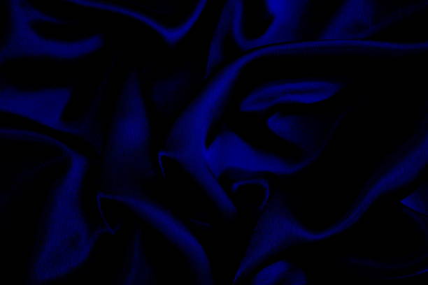 istock Background of draped blue satin fabric. 1403638464