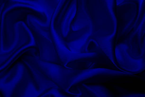 istock Background of draped blue satin fabric. 1403638520