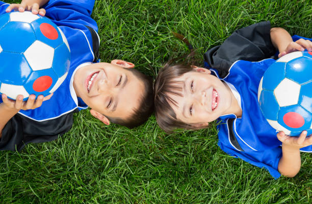 Sibling soccer portrait stock photo
