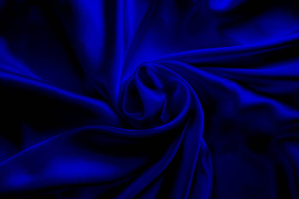 istock Background of draped blue satin fabric. 1403638774