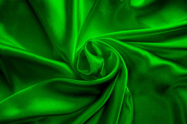 istock Background of draped green satin fabric. 1403638778