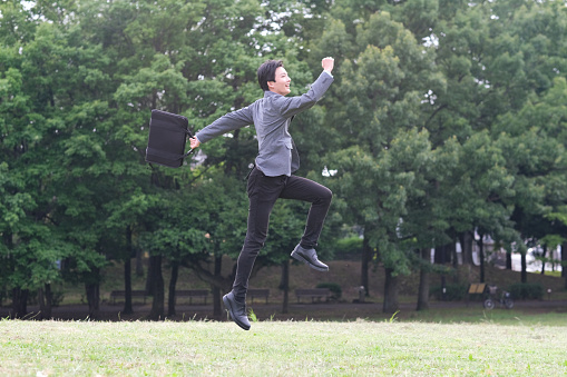 Jumping joyful businessman