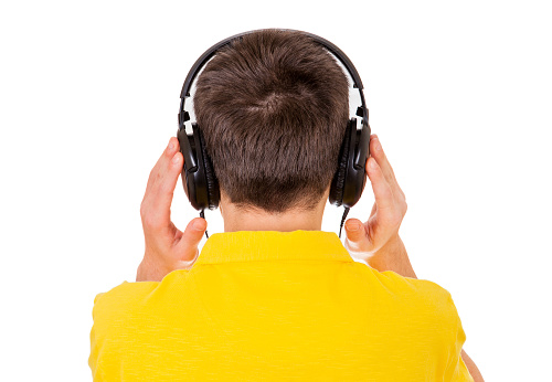 Rear View of the Young Man in Headphones on the White Background