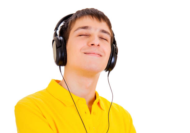 Young Man in Headphones listen to the Music on the White Background