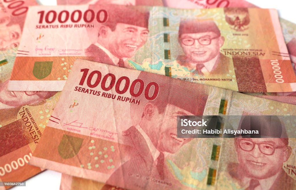 Indonesia banknotes of 100000 rupiah isolated on white background. Bank - Financial Building Stock Photo