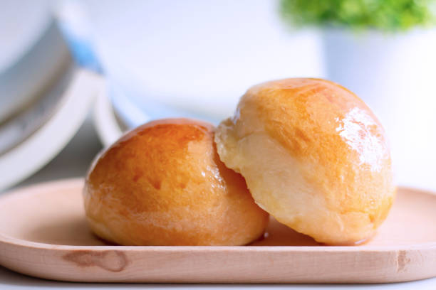 istock Two butter bread bun  on wooden plate with book 1403643546
