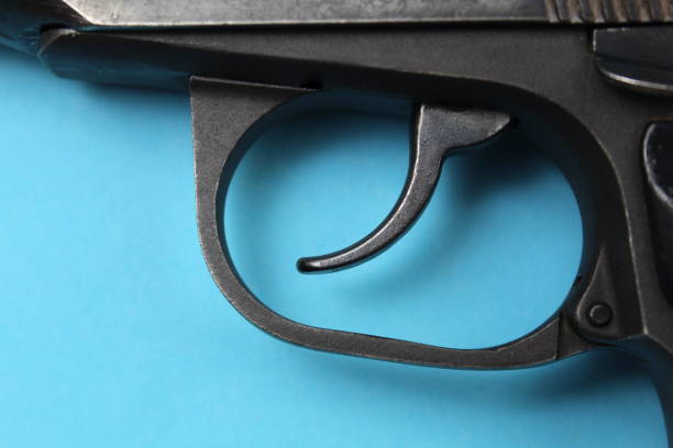 istock An iron pistol lies on a blue background. 1403644203