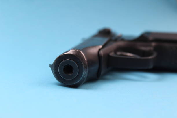 istock An iron pistol lies on a blue background. 1403644224