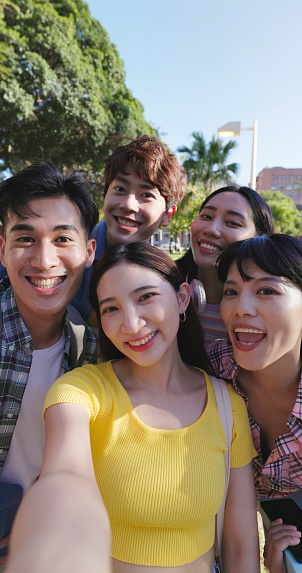 point of view happy young asian teenagers take selfie on smartphone and they smile happily