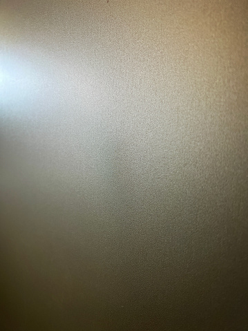 A macro image of a white wallpaper in the dark as a texture or background.