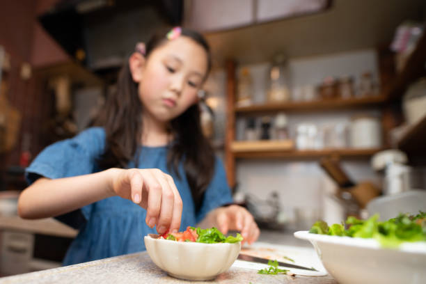 istock Girl making salad at home 1403648057