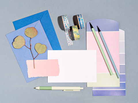 Marine style mockup with colour samples palette and office supplies for artist, designer or student. Home office concept for remote work or studying. Summertime memories and drawings template.