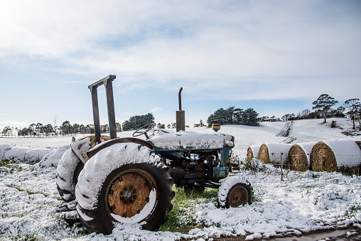 An old tractor abandoned in the snow