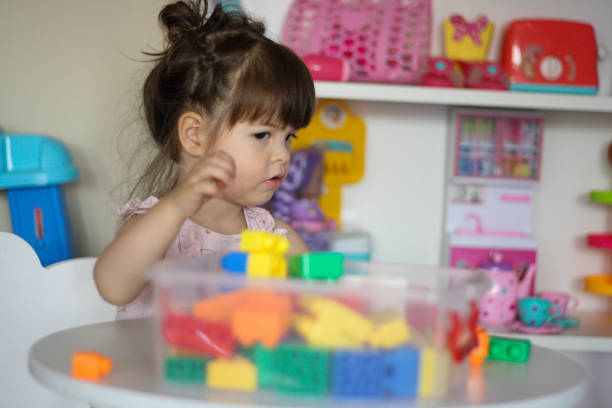 istock The child is looking at the plastic cubes (toy blocks) 1403655942