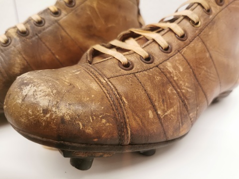 Old dirty shabby shoes on a white background