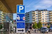 Close up of parking sign for charging electric vehicles in parking lot near mall. Sweden.