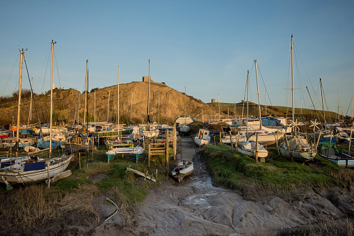 View of the boats alongside the Uphill marina, nestled in an old quarry under Uphill Hill where part of the recent ITV series of Sanditon was filmed. You can walk to the watch tower and 12th century church on the hill overlooking the site. Located by the River Axe at Weston-super-Mare, and approximately 6 miles from the M5 motorway.