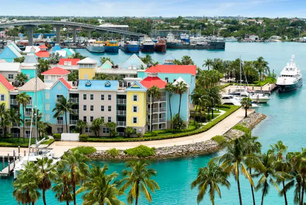 Aerial view of Paradise Island harbor and Nassau with vibrant colored condos and yachts.