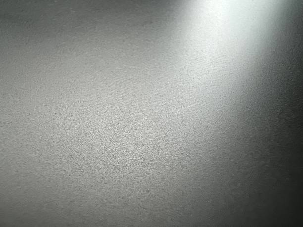istock A fine black and metallic plastic with bright light as texture or background. 1403663923