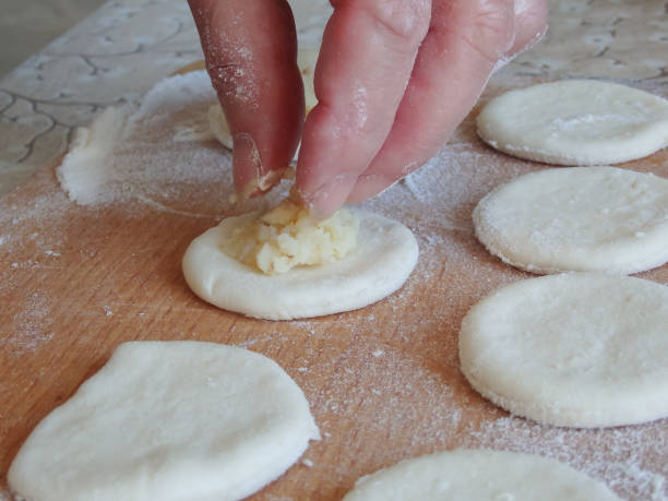 istock Cooking dumplings stuffed with yeast dough. Making traditional dumplings 1403664315