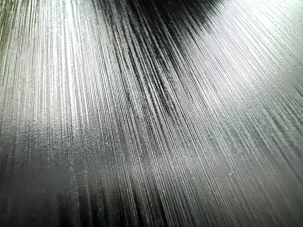 A macro image of a shiny, black and fine plastic with traces. stock photo