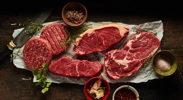 istock Raw burger cutlets and beef steaks with various condiments 1403665812