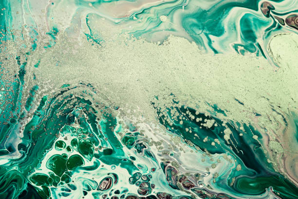 istock Fluid Art acrylic paints. Abstract mixing green waves and golden sand. Liquid flows splashes. Marble effect background or texture 1403669721