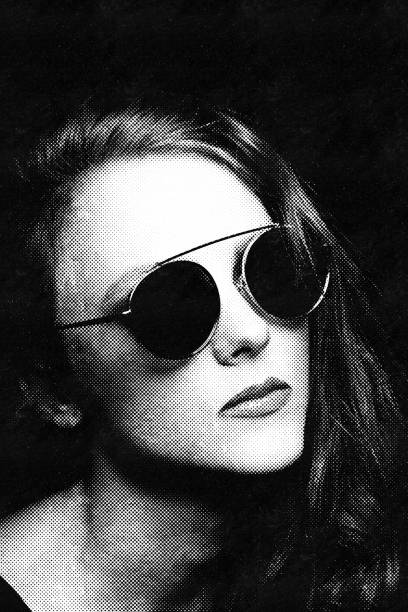 istock Beautiful woman with sunglasses close-up studio portrait in halftone pattern 1403670818