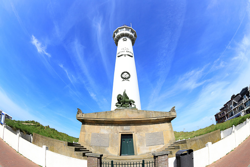 Egmond aan Zee, the Netherlands - May 22, 2022: Visiting the J.C.J. van Speijck Lighthouse in Egmond aan Zee in North Holland a sunny day in May.