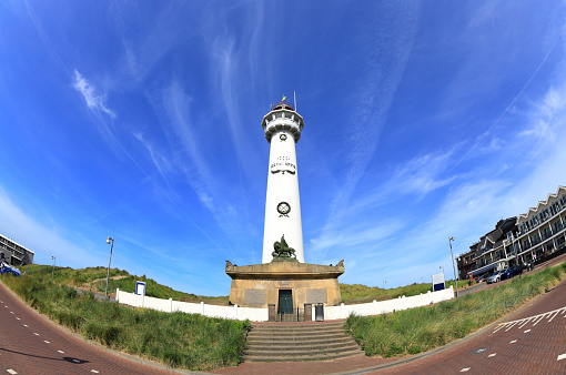 Egmond aan Zee, the Netherlands - May 22, 2022: Visiting the J.C.J. van Speijck Lighthouse in Egmond aan Zee in North Holland a sunny day in May.