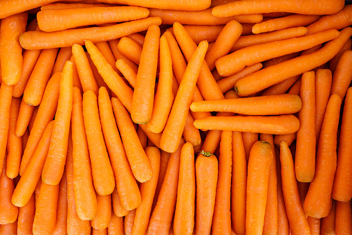 Many carrots placed raw in a container, overhead photo