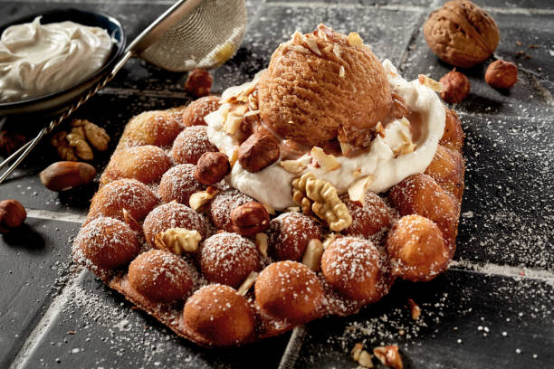 Traditional bubble waffle with nutty ice-cream and fresh nuts