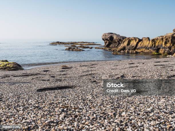 Small Stone Beach Shore In The Mediterranean Sea On The Costa Del Sol Transparent Water And Eroded Rocks In Manilva Stock Photo - Download Image Now