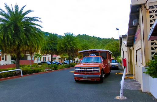 St. Thomas, USVI - May 4, 2022: The excursion or tour by bus on St. Thomas, USVI in US Virgin Islands - travel concept. Transporation to a beach on a from a boat dock to the beach on a Caribbean island. Sightseeing car